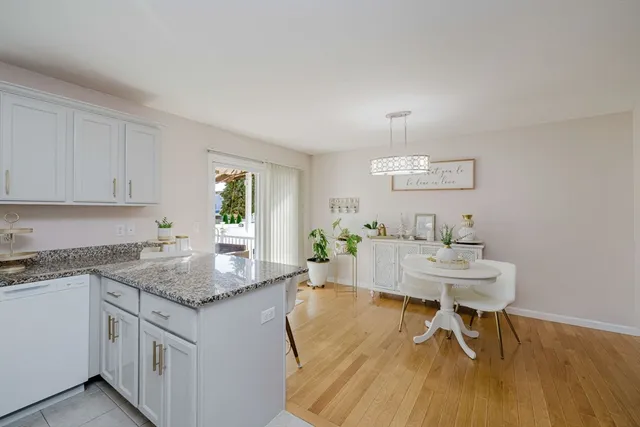 a living room with granite countertop furniture and a wooden floor