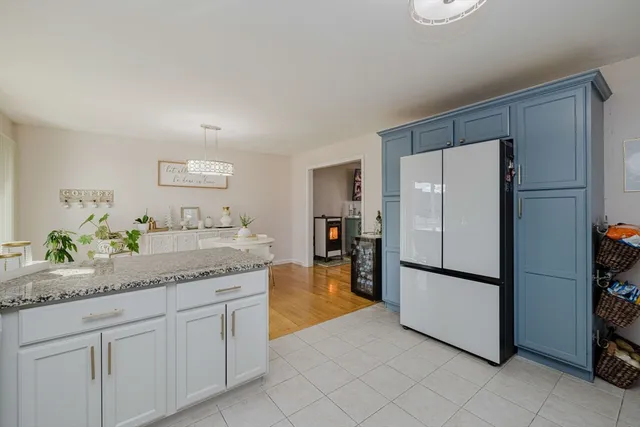 a kitchen with granite countertop stainless steel appliances a refrigerator and a sink