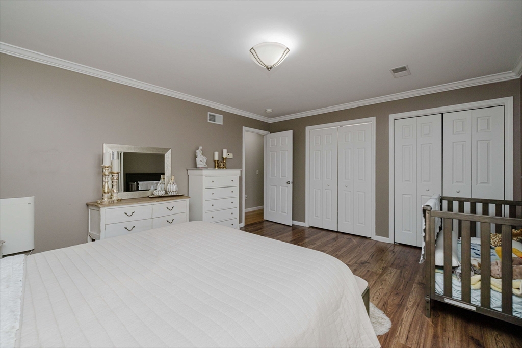 20 Reeves Street Fall River, MA 02721 - Photo 22 of 42 a large bedroom with a bed and a flat screen tv