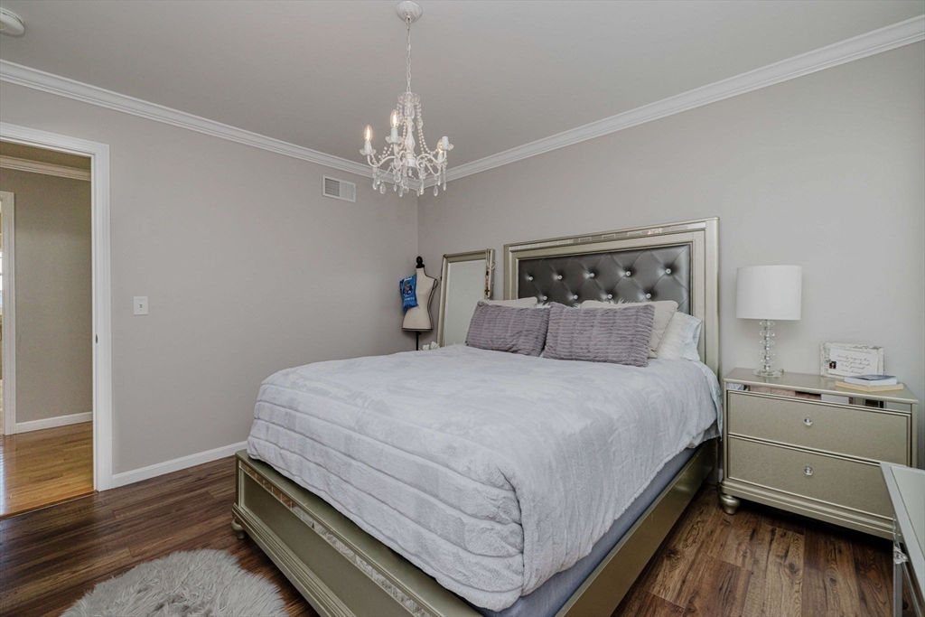 20 Reeves Street Fall River, MA 02721 - Photo 24 of 42 a bed room with a bed and a chandelier