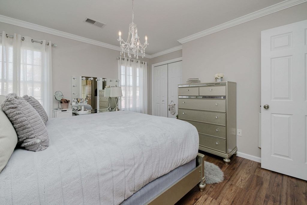 20 Reeves Street Fall River, MA 02721 - Photo 25 of 42 a bedroom with a bed and a chandelier