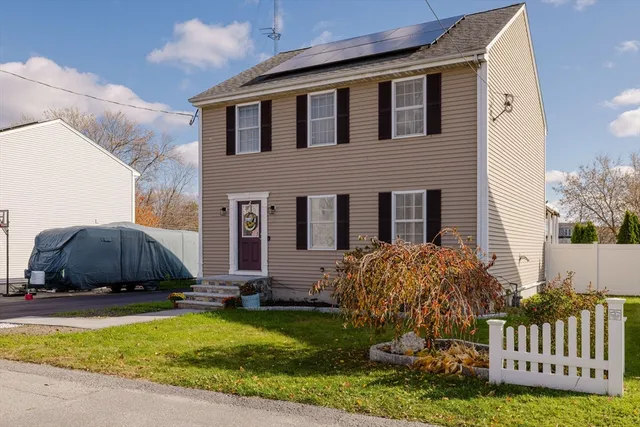 a front view of house with yard and outdoor seating