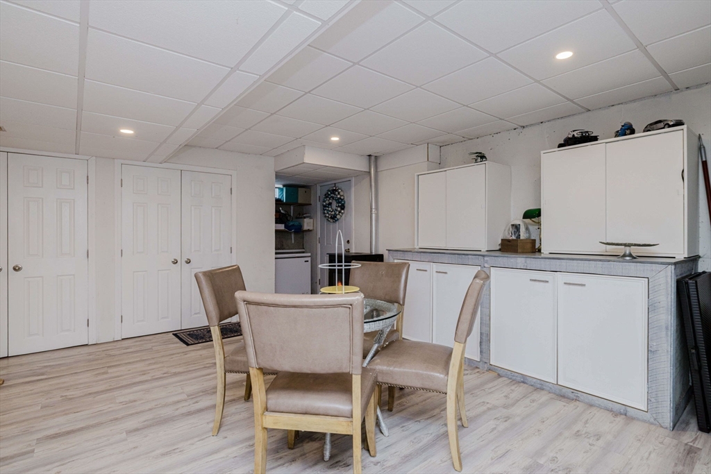 20 Reeves Street Fall River, MA 02721 - Photo 33 of 42 a kitchen with a dining table chairs and white cabinets