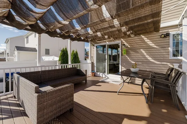 a view of a patio with table and chairs with wooden floor and fence