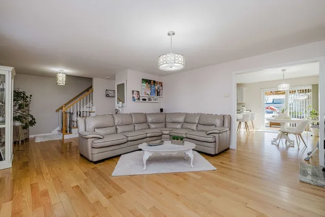a living room with furniture wooden floor and a chandelier