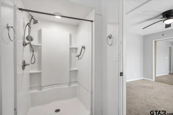 a bathroom with a shower and a tub