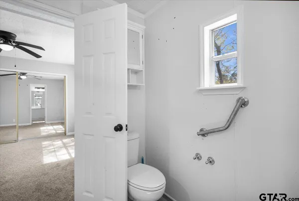 a bathroom with a toilet and a shower
