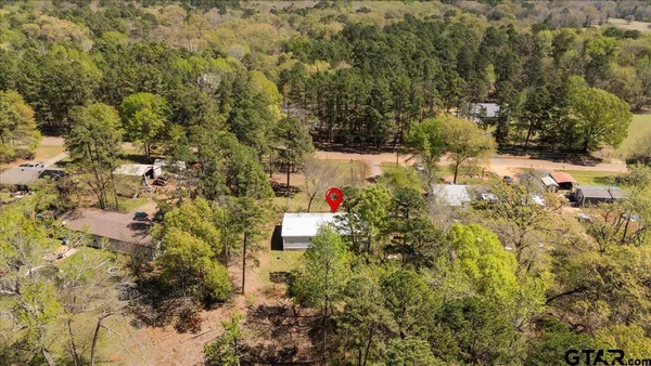 a backyard of a house with large trees