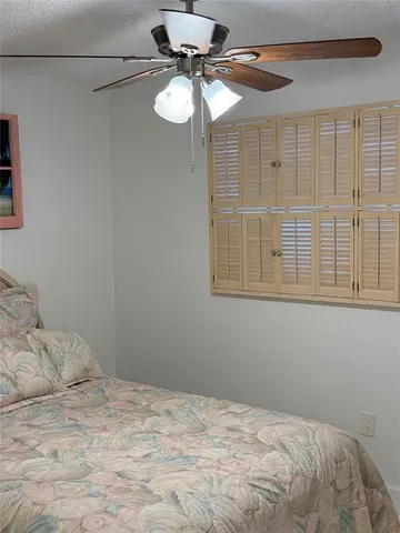 a bedroom with a bed and chandelier