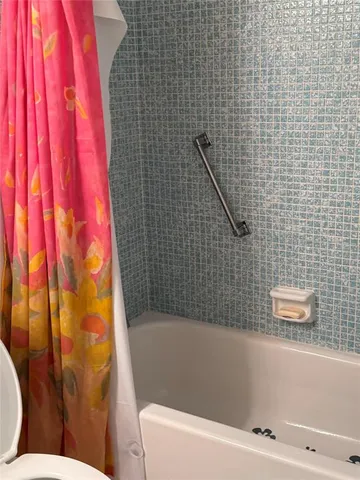 a bathroom with a bathtub and shower