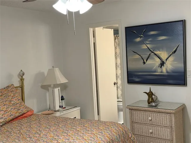 a bedroom with a bed and a lamp on table