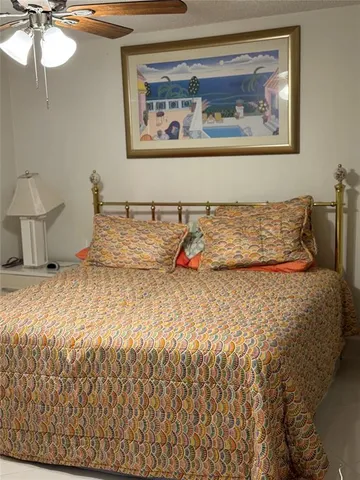 a bedroom with a bed and a painting on the wall