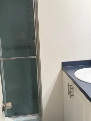a bathroom with a shower and a sink