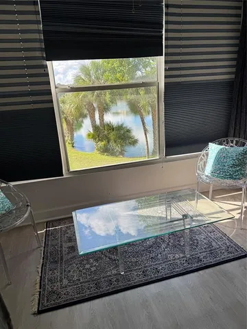 a view of a floor to ceiling window and a wooden floor