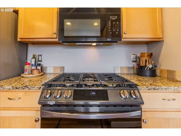 a stove top oven sitting inside of a kitchen
