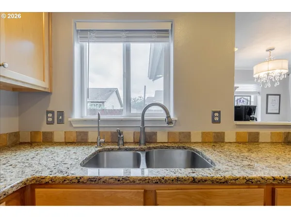 a kitchen with kitchen island granite countertop a sink a counter top space and cabinets