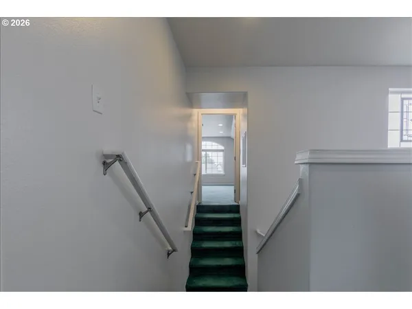 a view of a hallway with stairs
