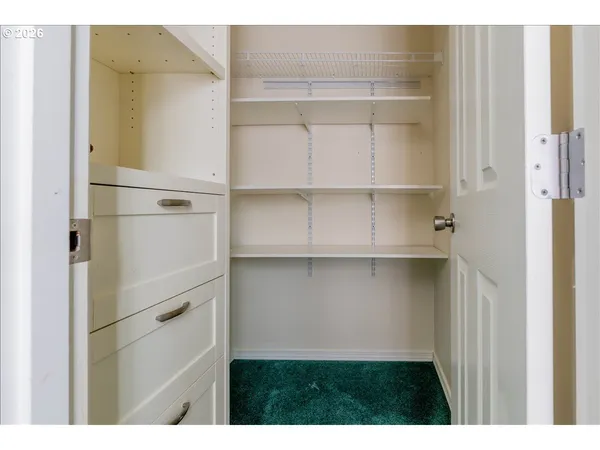a view of walk in closet with empty racks