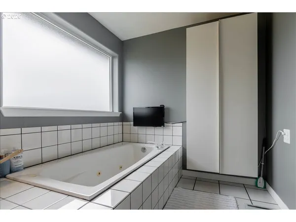 a bathroom with a tub and a sink