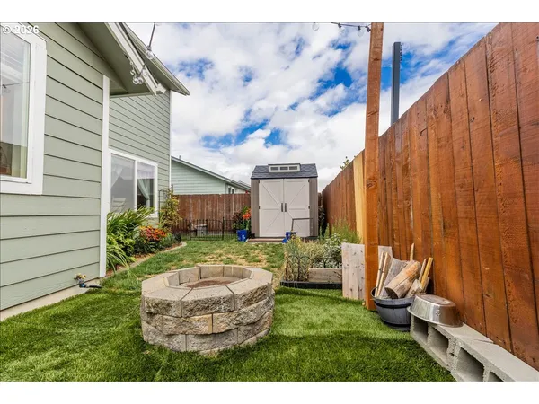 a backyard of a house with table and chairs