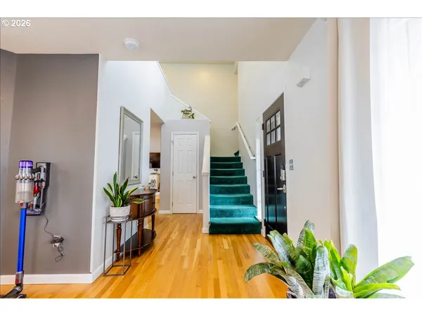a view of an entryway with wooden floor