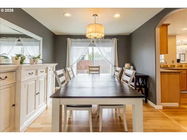 a kitchen with a table chairs and white cabinets