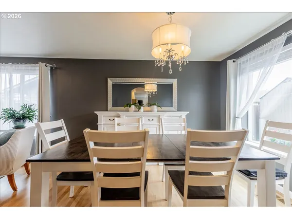 a view of a dining room with furniture and chandelier
