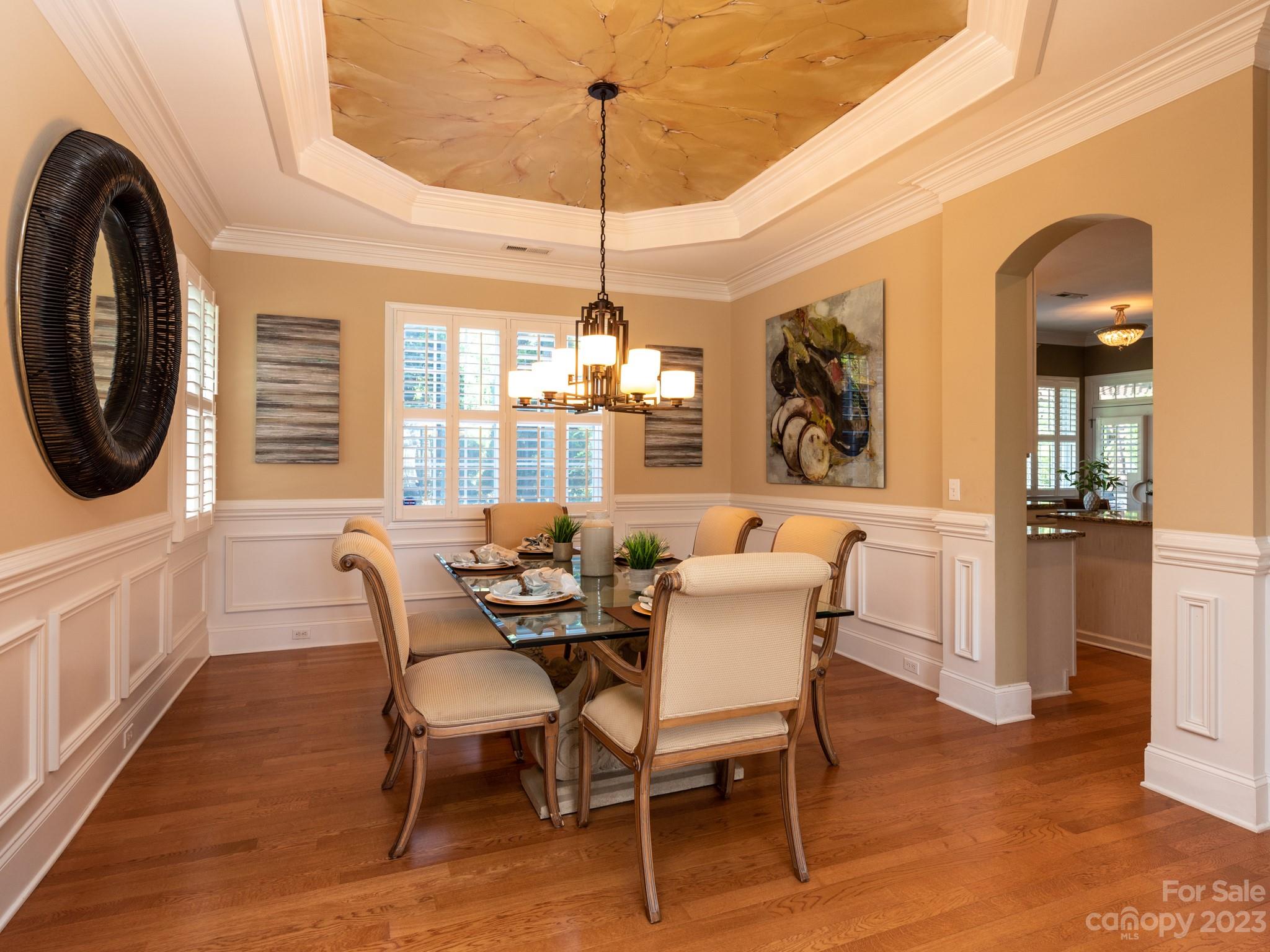 11510 Wheat Ridge Road Charlotte, NC 28277 - Photo 13 of 48 a dining room with furniture a chandelier and wooden floor