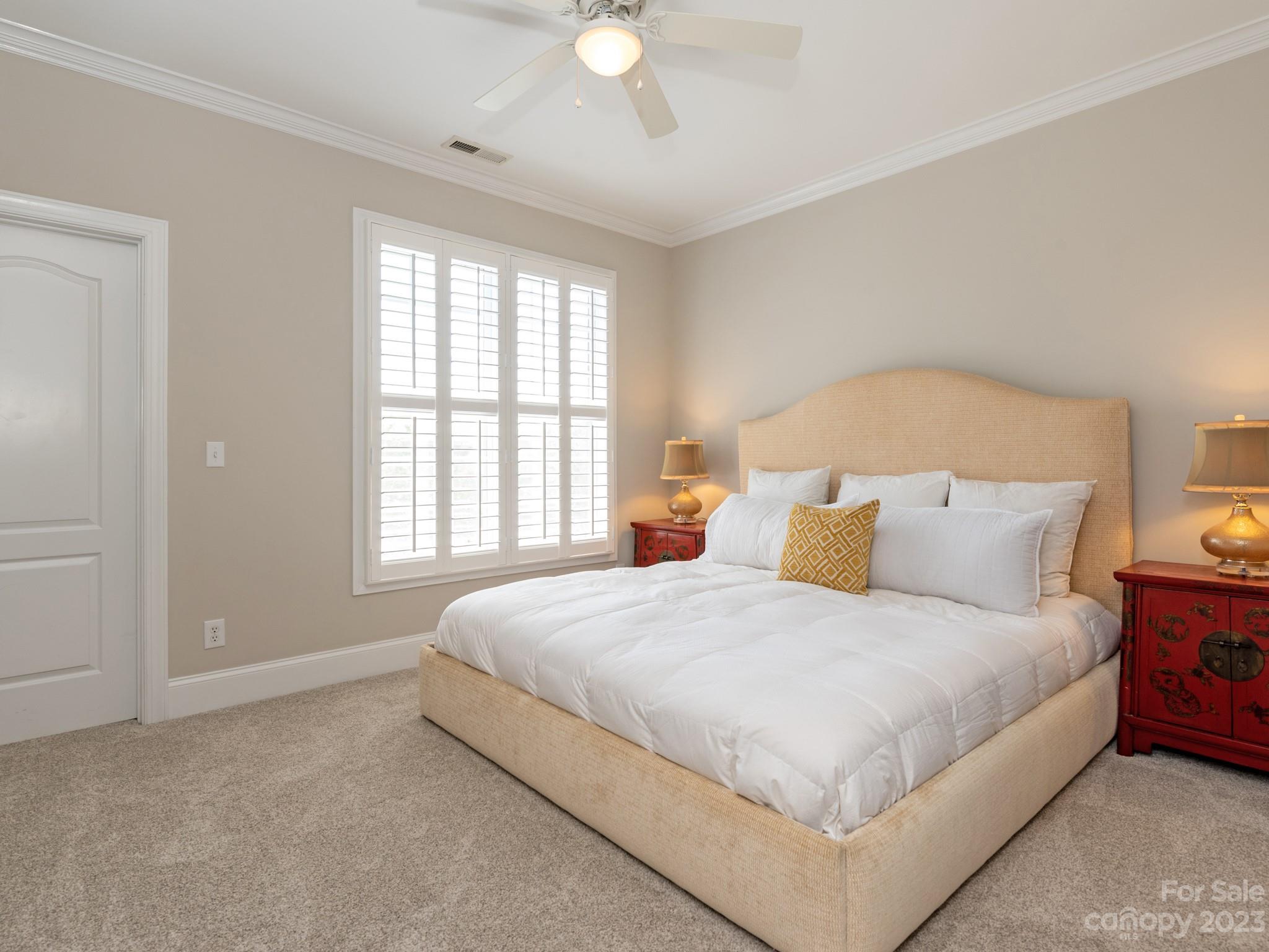 11510 Wheat Ridge Road Charlotte, NC 28277 - Photo 28 of 48 a bedroom with a large bed and a chandelier fan