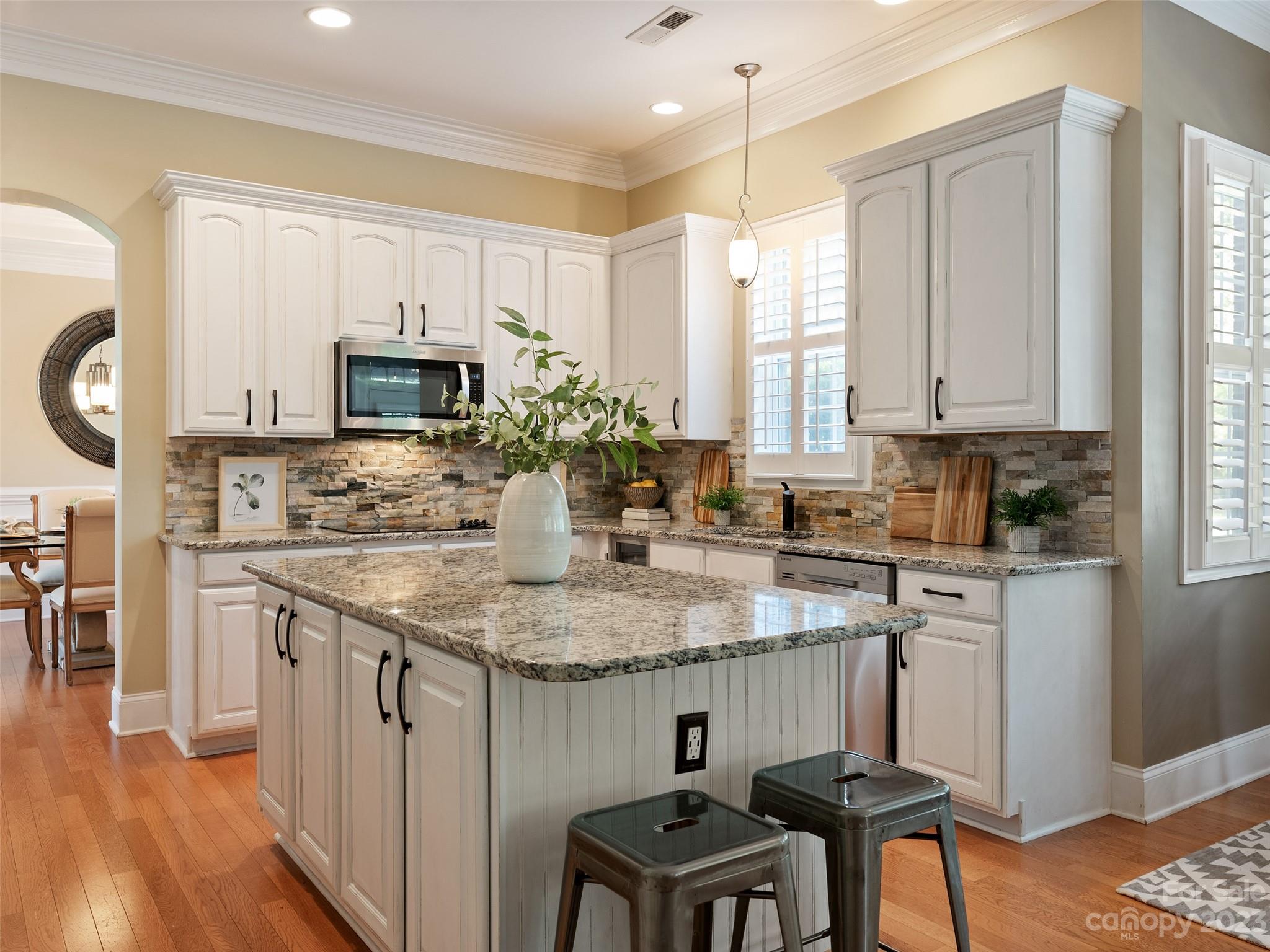 11510 Wheat Ridge Road Charlotte, NC 28277 - Photo 7 of 48 a kitchen with kitchen island granite countertop a sink a stove a microwave and cabinets