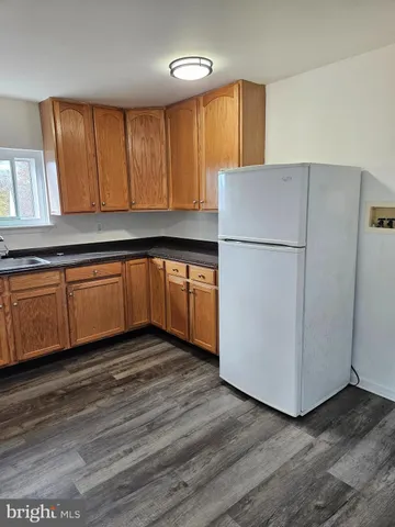 a kitchen with a refrigerator and a sink