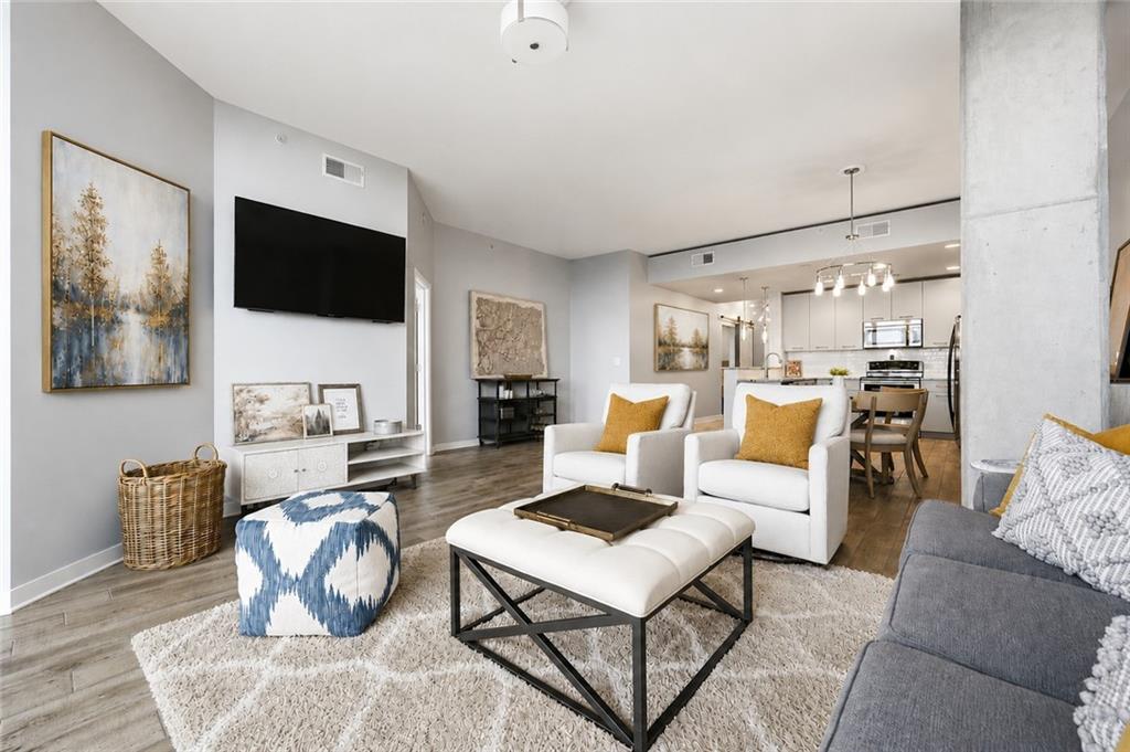 3300 Windy Ridge Parkway Southeast, Unit 1112 Atlanta, GA 30339 - Photo 14 of 43 a living room with furniture and a flat screen tv