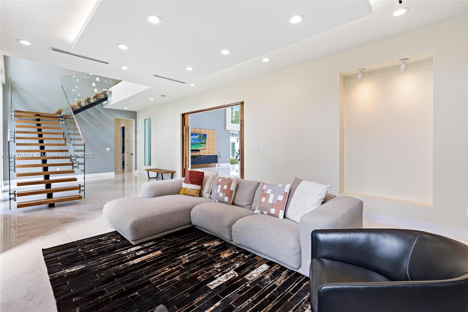 143-xx Stirling Road Southwest Ranches, FL 33330 - Photo 11 of 76 a living room with furniture and a wooden floor