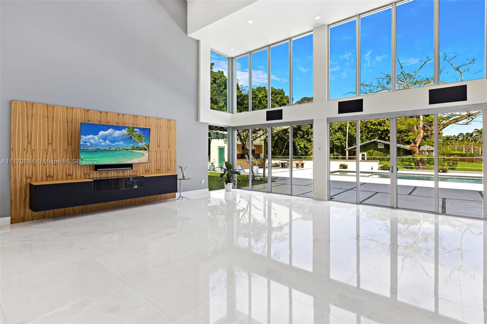 143-xx Stirling Road Southwest Ranches, FL 33330 - Photo 20 of 76 a living room with large window and a flat screen tv