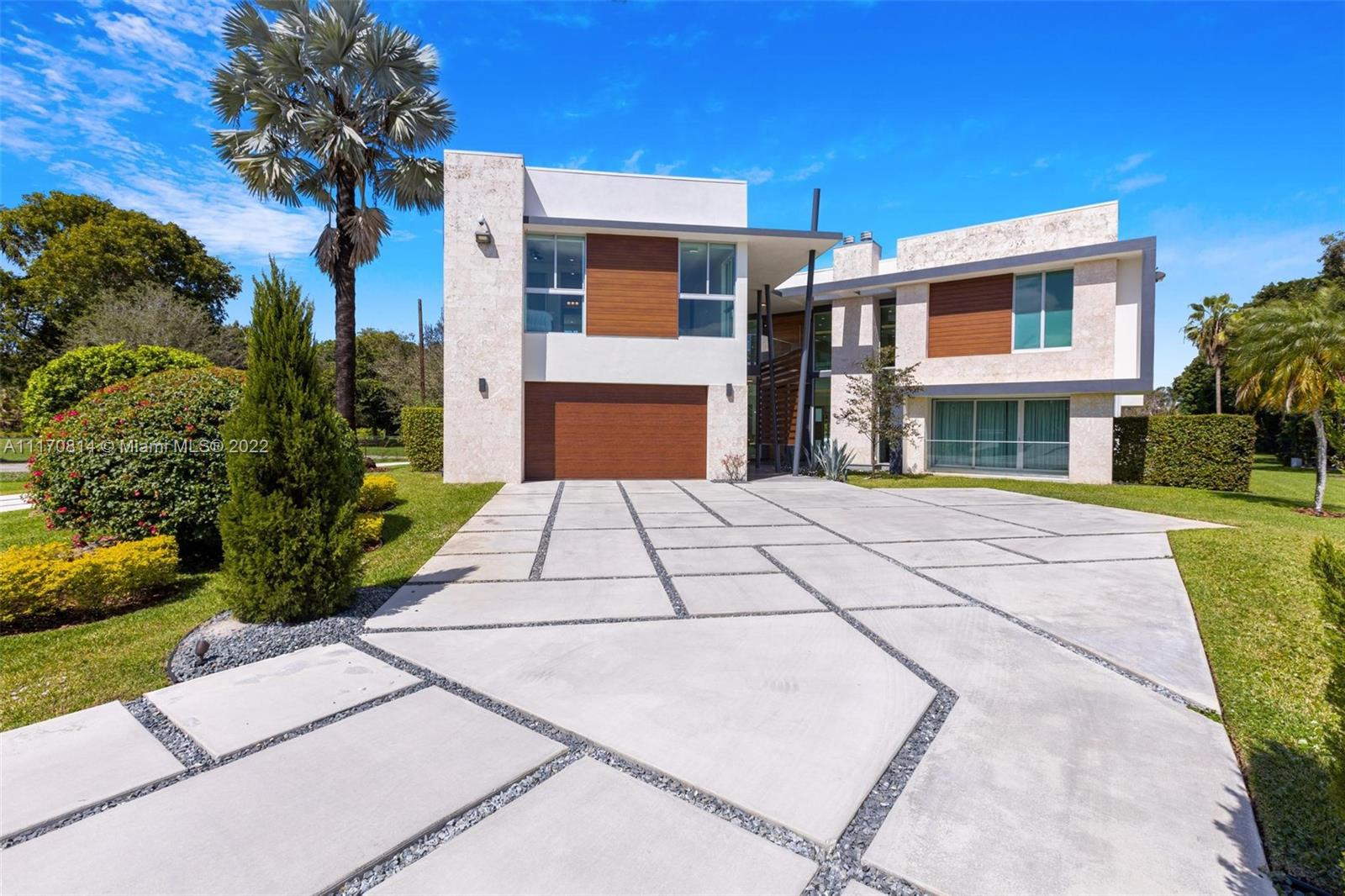 143-xx Stirling Road Southwest Ranches, FL 33330 - Photo 5 of 76 a front view of a house with a garden