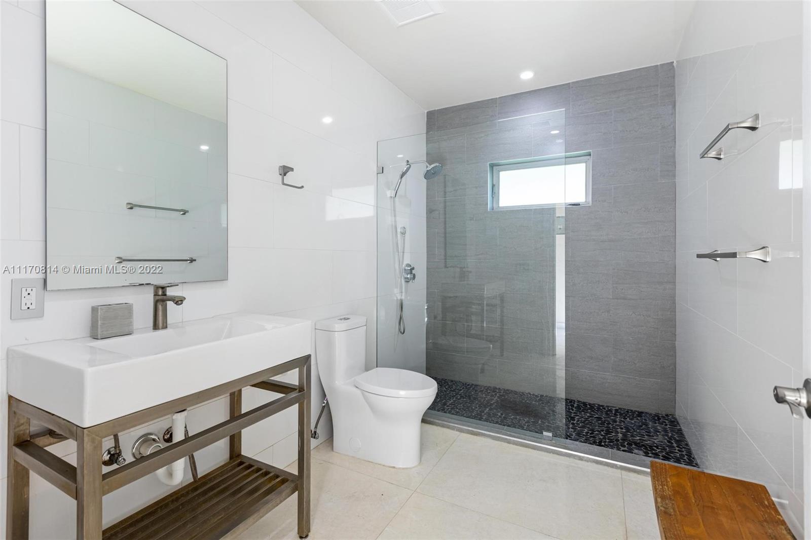 143-xx Stirling Road Southwest Ranches, FL 33330 - Photo 54 of 76 a bathroom with a sink toilet a mirror and shower