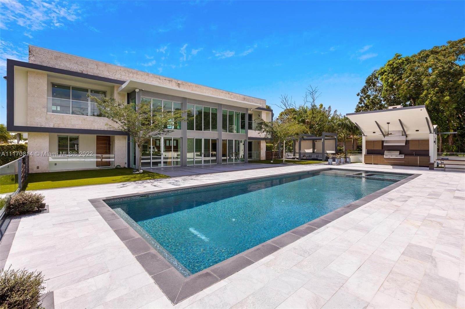 143-xx Stirling Road Southwest Ranches, FL 33330 - Photo 56 of 76 a view of swimming pool with outdoor seating and house in the background