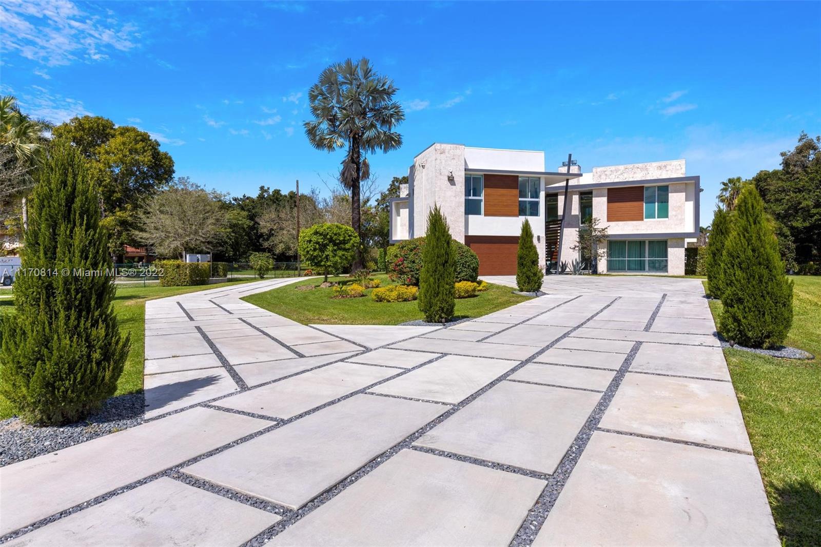 143-xx Stirling Road Southwest Ranches, FL 33330 - Photo 7 of 76 a front view of a house with a yard and potted plants