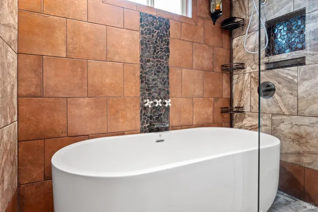 a white bath tub sitting in a bathroom