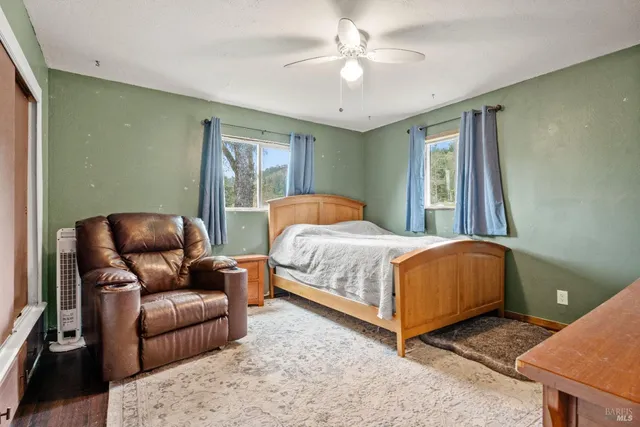 a bedroom with a bed couch and window