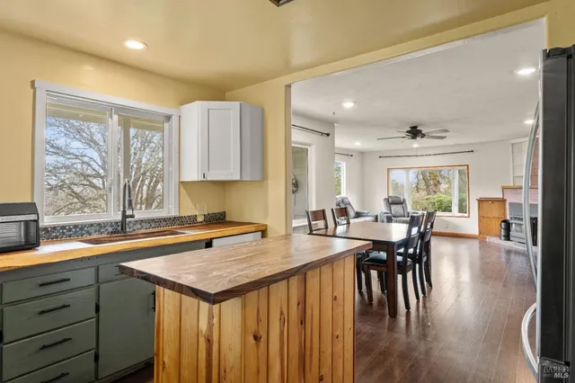 a kitchen with a table chairs and wooden floor