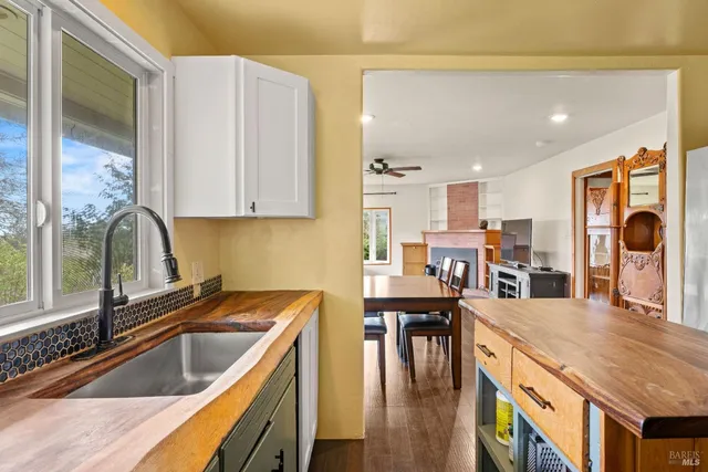 a kitchen with a table chairs stove and cabinets