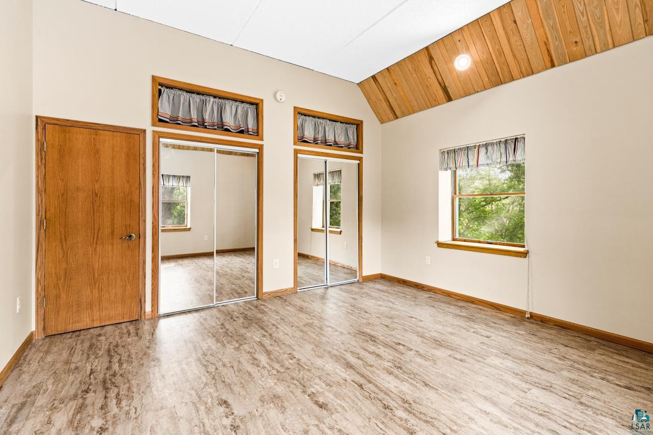 4800 Tower Road Moose Lake, MN 55767 - Photo 66 of 83 Vaulted wood-paneled ceiling, wood-finish flooring, and a window with exterior views