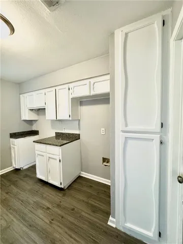 a kitchen with white cabinets and white appliances