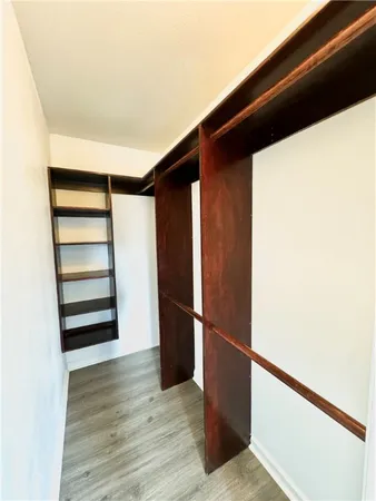 a view of walk in closet with empty racks