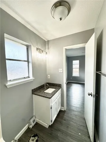 a kitchen with a refrigerator and windows