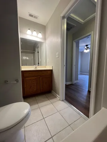 a bathroom with a sink a toilet and mirror