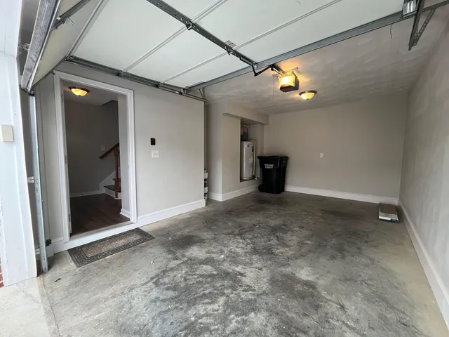 a view of a big room with wooden floor and windows
