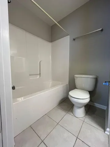 a bathroom with a toilet and a bathtub