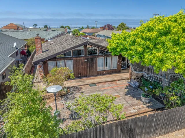 an aerial view of a house with a yard and outdoor seating